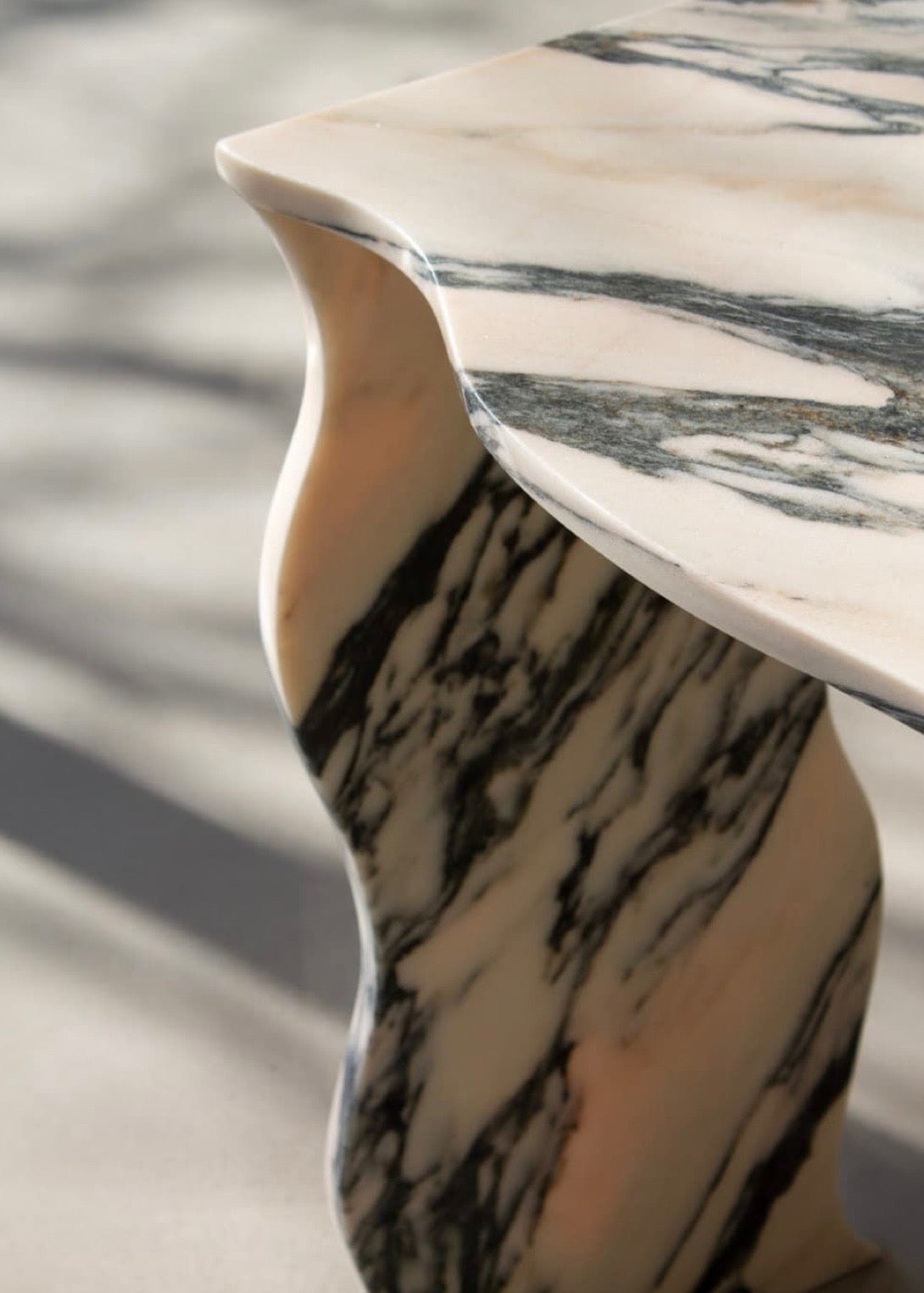 Curved marble side table