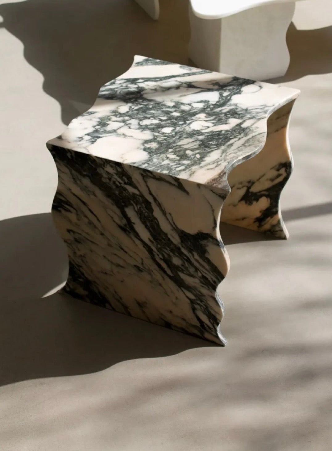 Curved marble side table